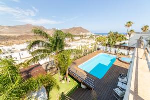 an aerial view of a resort with a swimming pool and palm trees at Villa Lux in Níjar
