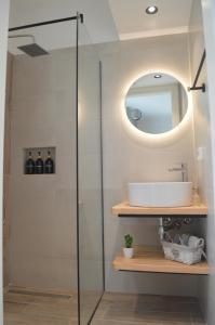a bathroom with a glass shower with a sink at Beyond in Argostoli