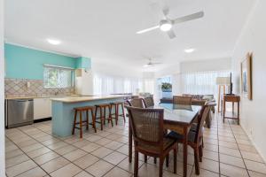 a kitchen and dining room with a table and chairs at Noosa River Gardens 1 Hilton Terrace 76 in Tewantin