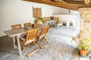 a living room with a wooden table and chairs at Il Casale in Teulada