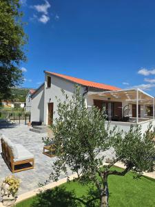 a villa with a patio and a house at House Angelina in Kruševo