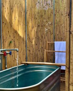 a jacuzzi tub in a room with a wooden wall at Retreat & Glamping Terre di Sacra in Toscana in Capalbio