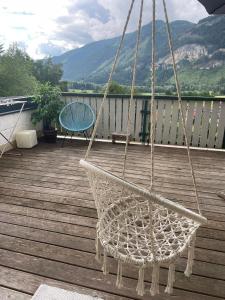 a hammock hanging on a deck with a chair at Haus Leona in Teufenbach
