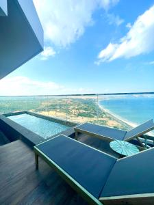 a building with a view of the ocean and a pool at Apec Mandala Chambay Mũi Né in Ấp Thiẹn Ái
