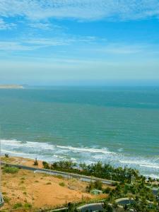 a view of a beach with the ocean at Apec Mandala Chambay Mũi Né in Ấp Thiẹn Ái