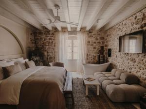 a bedroom with a large bed and a bath tub at Palazzo Caterina in Hvar