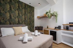 a bedroom with a bed with towels on it at 3K Rodo Rooms in Faliraki
