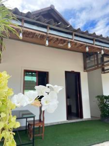 a house with a table and white flowers in the yard at Pich Mean Bungalow in Sihanoukville