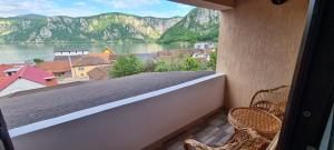 a balcony with a view of a river and mountains at Alexandra si Adan in Dubova