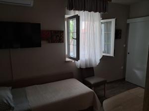 a hotel room with a bed and a window at Apartments Peričić in Podstrana