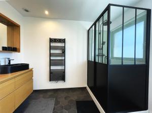 a kitchen with a large black door in a room at maison Porzh Loaz. in Plouézec