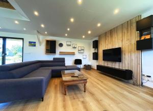 a living room with a couch and a tv at maison Porzh Loaz. in Plouézec