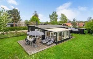 a house with a deck with a gazebo at Holiday Home Kirke Hyllinge 60 in Kirke-Hyllinge