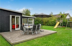 a patio with a table and chairs and an umbrella at Holiday Home Kirke Hyllinge 60 in Kirke-Hyllinge
