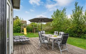 a patio with a table and chairs and an umbrella at Holiday Home Kirke Hyllinge 60 in Kirke-Hyllinge