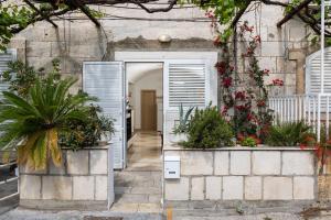 an open door to a house with plants at Beach Apartment Francesko near Old Town in Dubrovnik