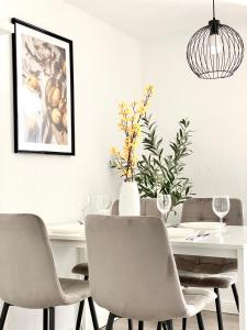 a dining room with a white table and chairs at City Apartment No1 in Reutlingen
