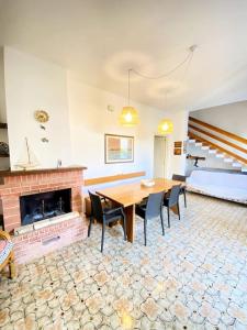 a dining room with a table and a fireplace at Il Foscolo in Torre dell'Orso