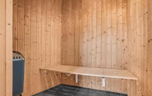 a wooden wall with a bench in a sauna at Nice Home In Glesborg With Sauna in Fjellerup Strand +18 photos
