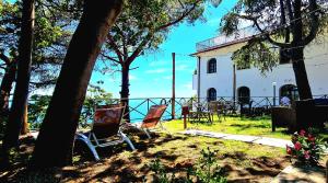 two chairs sitting in front of a building at Villa Blu Costiera in Amalfi