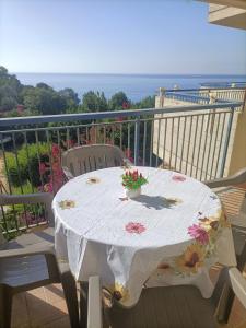 a white table with flowers on top of a balcony at Apartment Girasole in Acquedolci