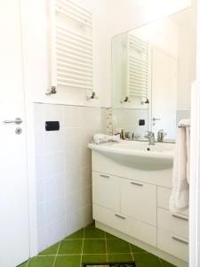 a white bathroom with a sink and a mirror at La Tortora in Cefalù +18 photos