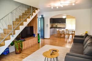 a living room with a couch and a staircase at Vila MOON in Bezdead