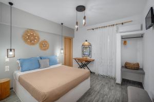 a bedroom with a bed and a table in it at Dorkas Luxury Rooms&Apartments in Livadakia