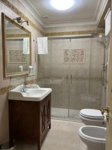 a bathroom with a shower and a sink and a toilet at Re Umberto 311 in Naples +35 photos