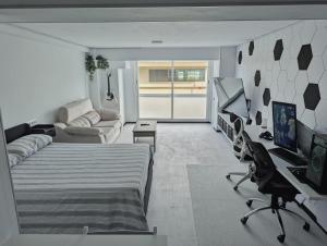 a bedroom with a bed and a living room at Estudio al mar en el Casco Vello de Vigo in Vigo