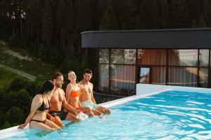 a group of people sitting in a swimming pool at WOL 07 by Ribas in Bukovel