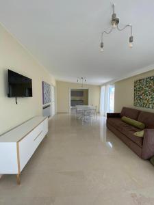 a large living room with a couch and a tv at Historico Loft & Rooms Palazzo Adragna XIX in Trapani