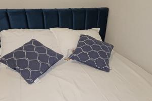 two pillows sitting on top of a bed at Ground floor Studio in Golem Next to Hotel Flower self check in 100m to beach in Golem