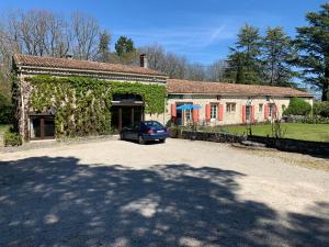 a car parked in front of a building with ivy at Stunning 18th Century Country House in Loubès-Bernac