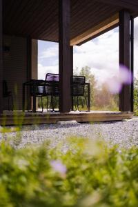 three chairs sitting on the porch of a house at Exclusive Suite in the Sunnmøre Alps, Near Geiranger & Hjørundfjord in Stranda