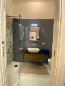 a bathroom with a sink and a glass shower at Manzoni 116 in Bari +12 photos