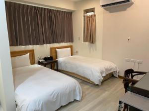 Letto o letti in una camera di Tianmu Star Urban Living