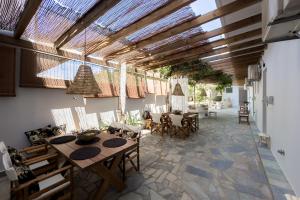 a dining room with wooden tables and chairs at Karystos Mare Apartments in Karistos