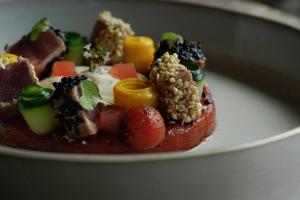 a plate of food with fruit and vegetables on it at Thalazur Arcachon in Arcachon