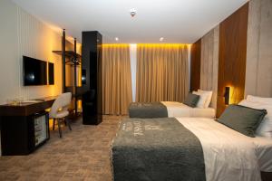 Łóżko lub łóżka w pokoju w obiekcie Hotel Consul