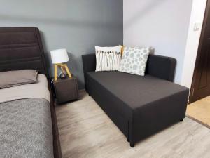 a bed and a couch in a room at ALFA BETA RESIDENCE in Saturn