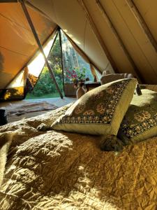 a bed in a tent with a pillow on it at Strandheimen Guesthouse in Melhus