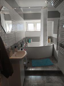 a bathroom with a bath tub and a sink at Rafaelo Władycze 17/4 in Przemyśl +14 photos