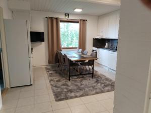 a kitchen and dining room with a table and chairs at Kuukkeli Sodankylä Aurora in Sodankylä