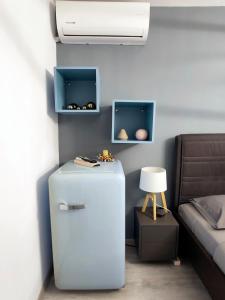 a room with a refrigerator and a bed at ALFA BETA RESIDENCE in Saturn