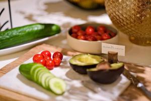 a table with fruits and vegetables on a cutting board at Thalazur Arcachon in Arcachon