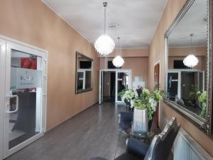 a living room with a table and chairs and mirrors at Rezydencja Rosato in Mirkow