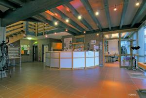 a large room with a kitchen with orange tile floors at Willi-Michels-Bildungsstätte in Hattingen
