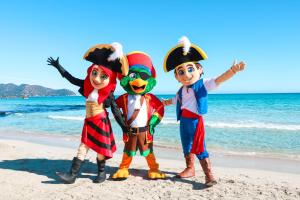 three kids dressed up in pirate costumes on the beach at Marins Playa in Cala Millor