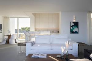 a living room with a white couch and a table at Big Blue Villas in Santa Maria +66 photos
